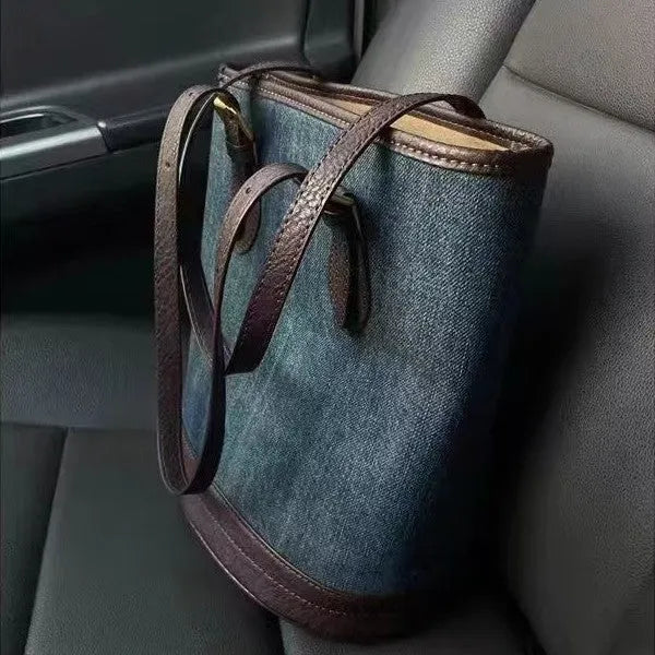Denim patchwork bucket handbag with one-shoulder strap showing 23x27x16cm dimensions