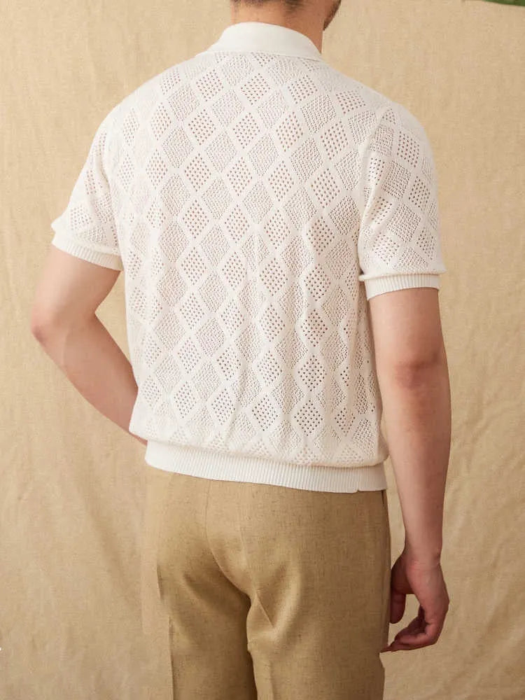 Front view of a white cotton cardigan with a zipper and lapel collar.