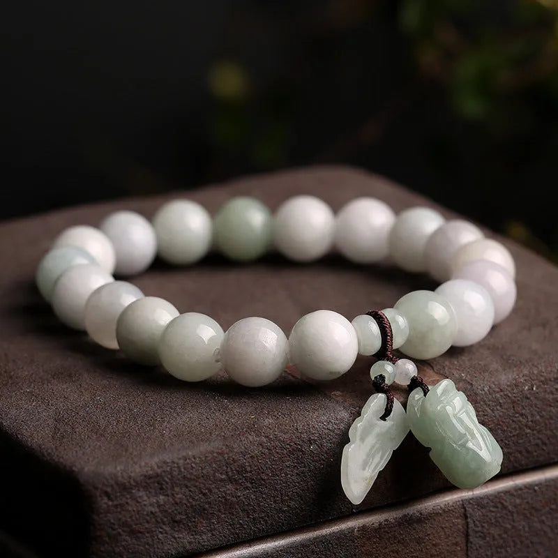 Jade hanging charm bracelet with geometric design and Buddhist symbolic pendant