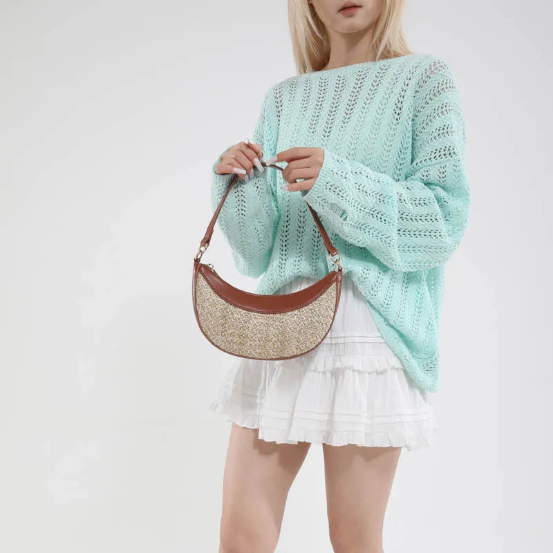 Straw dumpling-shaped crossbody bag with hard shell construction and contrast stitching details