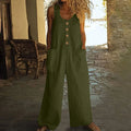 Sleeveless one-piece cotton jumpsuit in loose wide-leg style with side pockets, shown in Peacock Green colour.