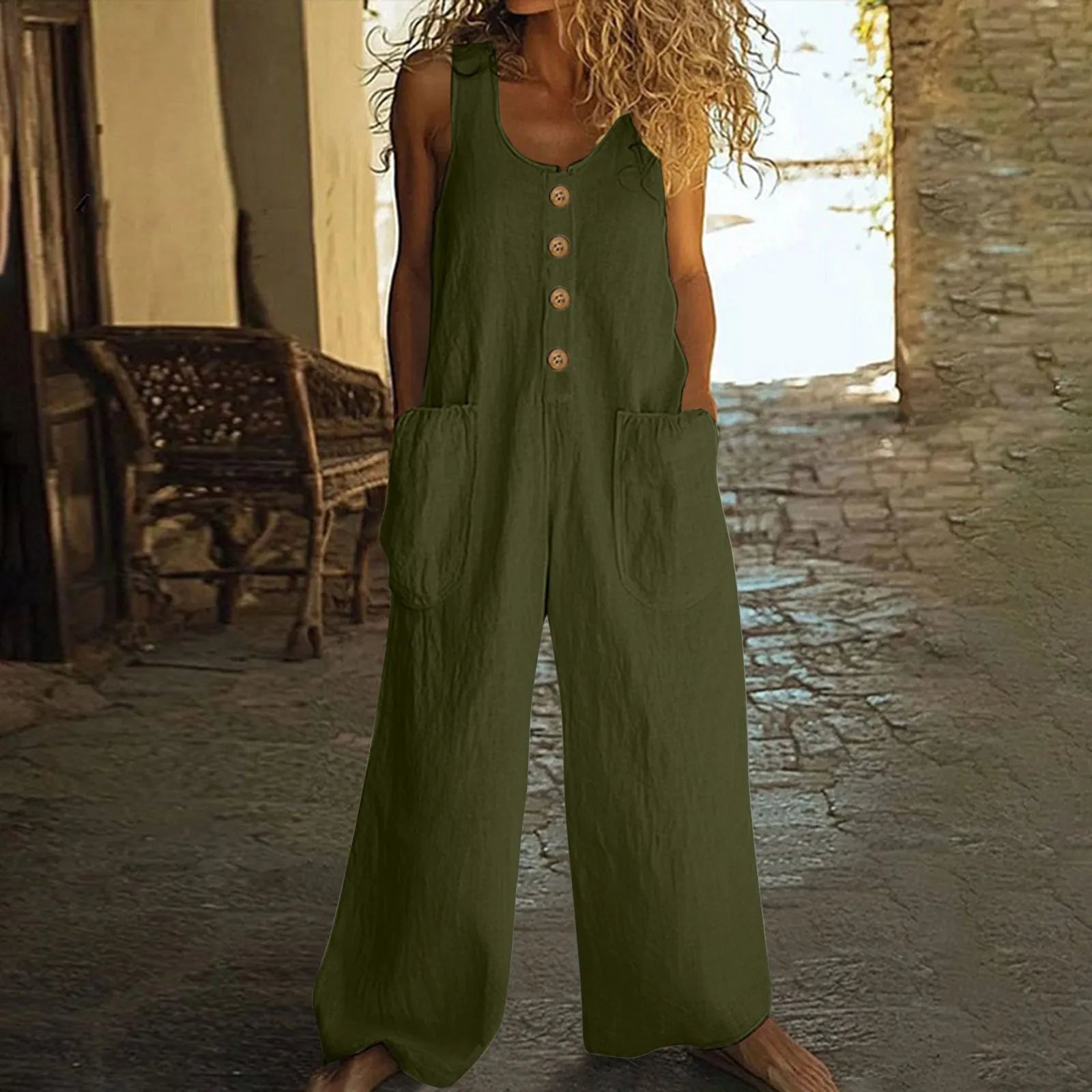 Sleeveless one-piece cotton jumpsuit in loose wide-leg style with side pockets, shown in Peacock Green colour.