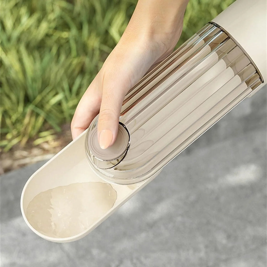 Beige and green foldable dog water bottle with food dispenser shown collapsed and open.