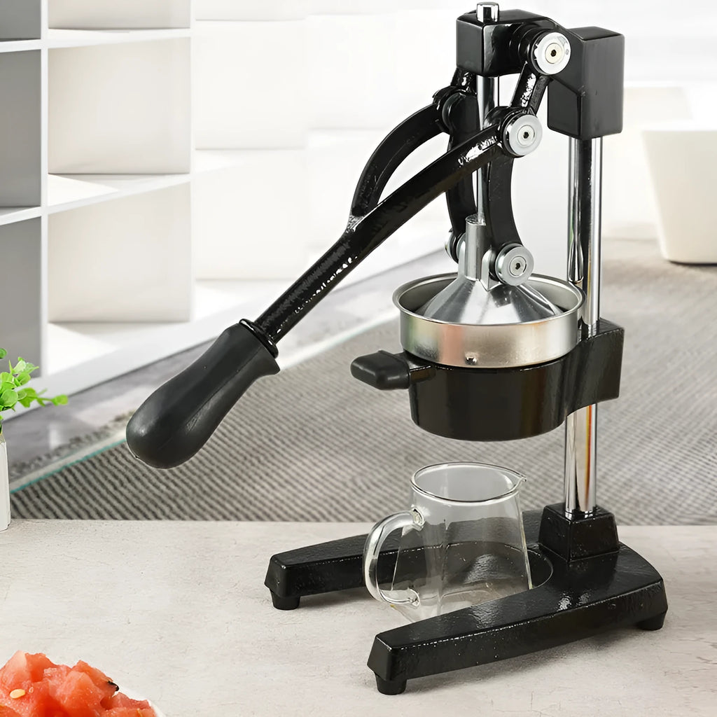 Black and white manual citrus juicer with cast iron base and stainless steel funnel, 40cm tall.