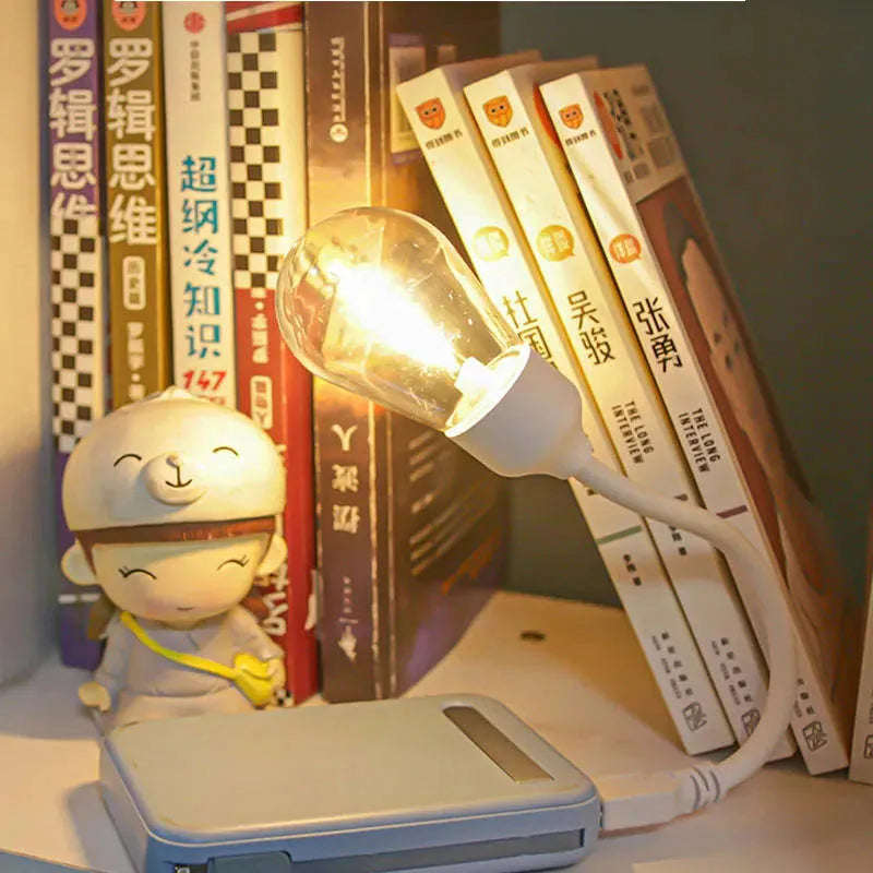 Folding USB rechargeable night light with glowing tungsten filament bulb.