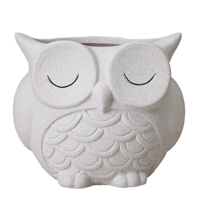 Handmade ceramic owl-shaped succulent plant pot in frosted light pink, shown from the front.