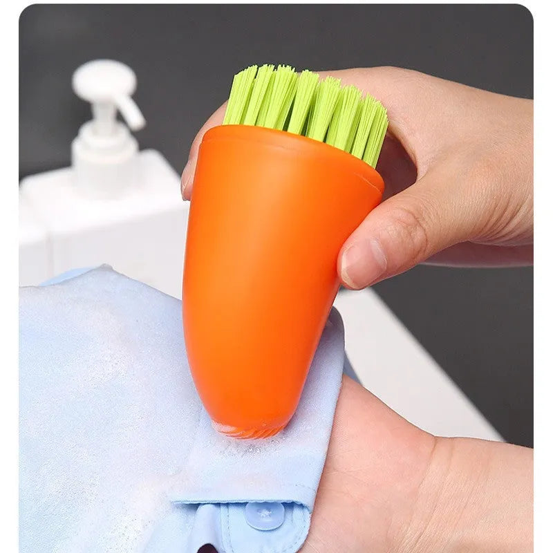 White and orange carrot-shaped nylon kitchen cleaning brush with dense bristles.