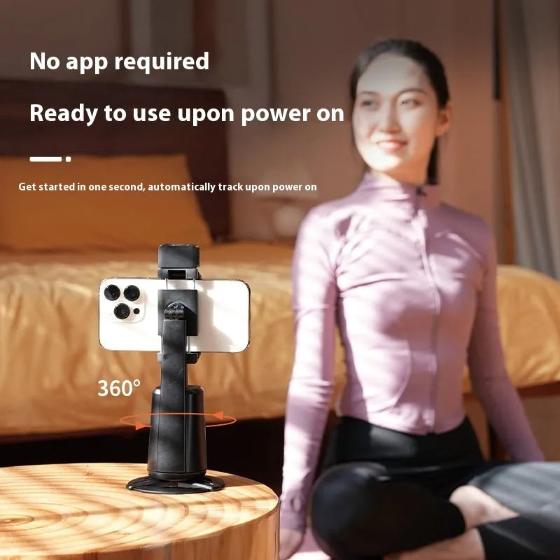 Black desktop phone bracket with rotating camera head and LED ribbon lights for face tracking video calls