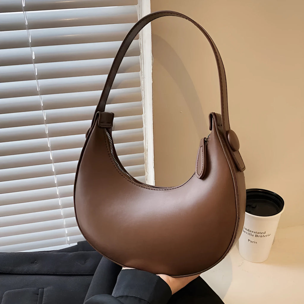 Women's retro PU leather shoulder bag in dumpling shape with zipper pocket, showing cream yellow colour option