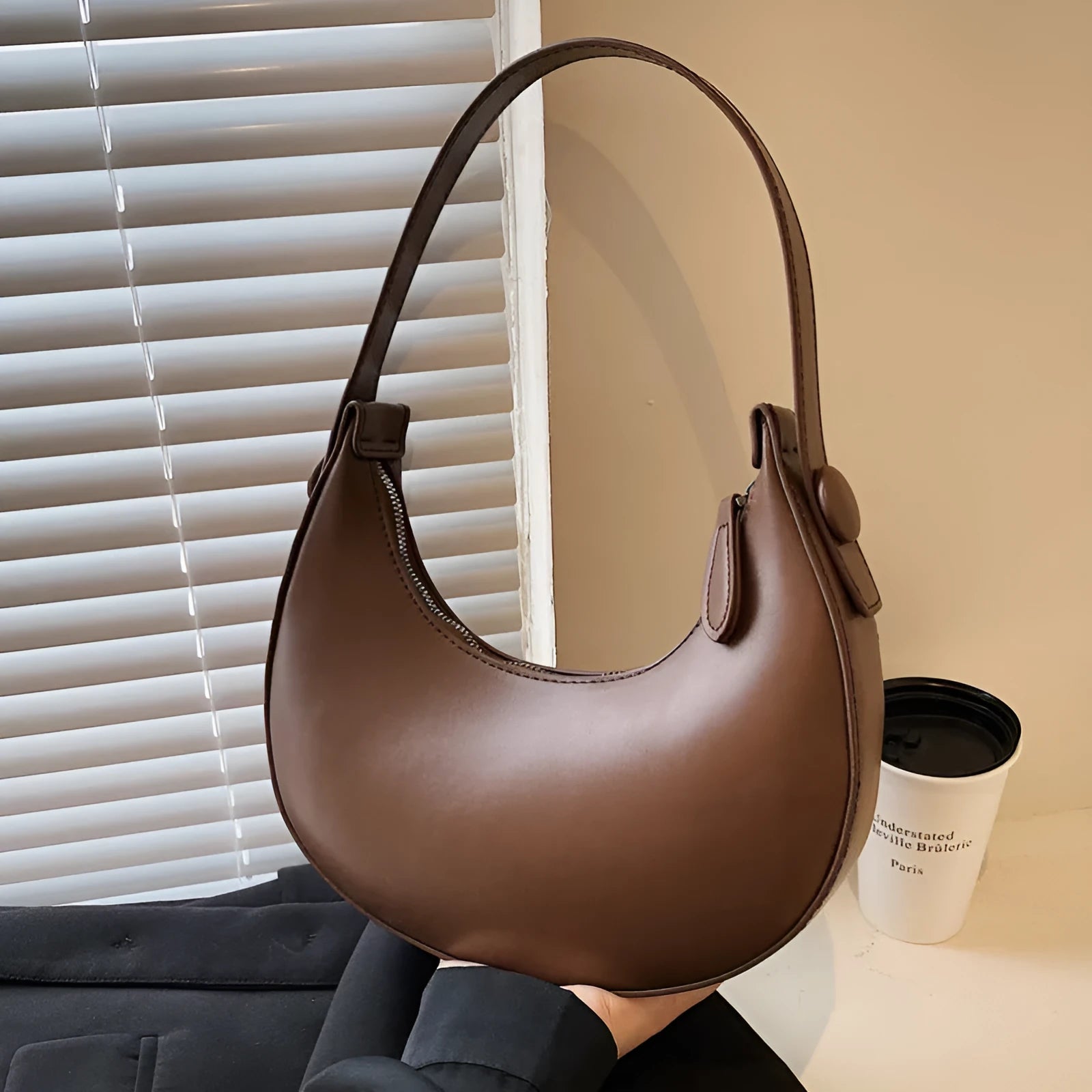 Women's retro PU leather shoulder bag in dumpling shape with zipper pocket, showing cream yellow colour option