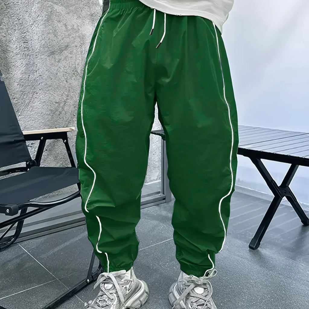 Man wearing blue loose-fit cropped sports trousers made from bamboo fibre.