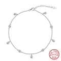 Women's silver geometric zirconium pendant anklet on an ankle, shown in gold and platinum colour options.
