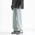 Men's light blue straight leg cotton jeans with a button waist closure laid flat.
