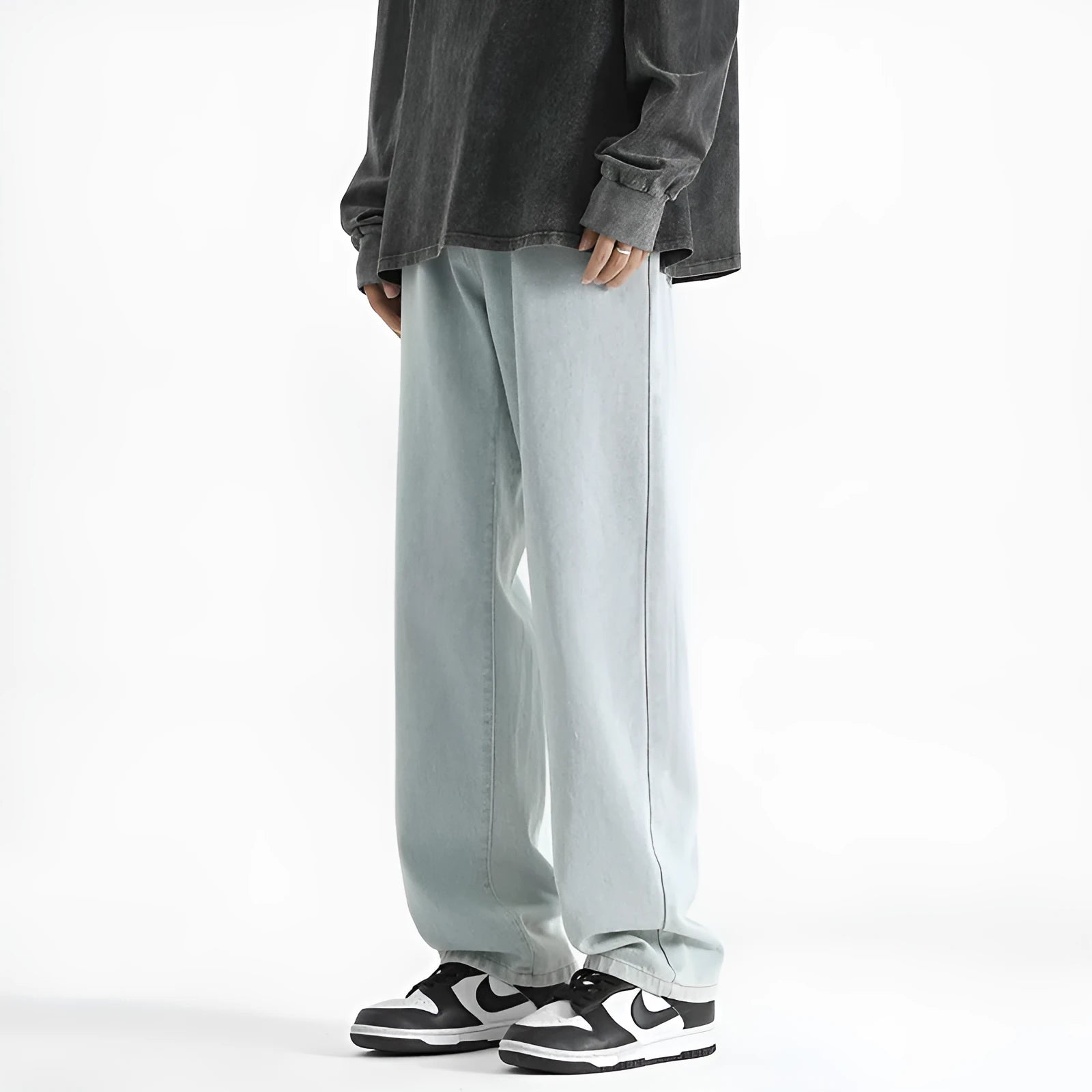 Men's light blue straight leg cotton jeans with a button waist closure laid flat.