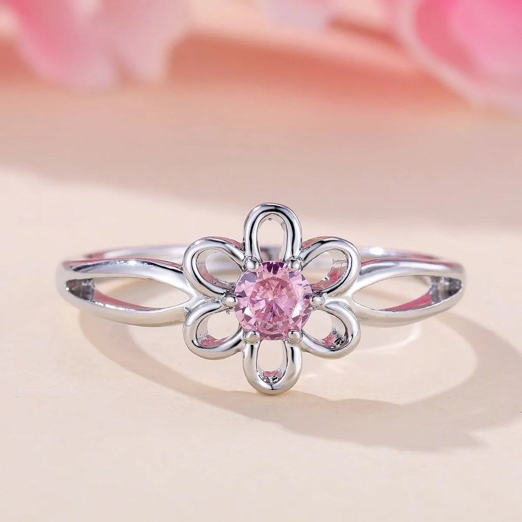 Women's flower-shaped hollow-out copper fashion ring in platinum pink diamond colour.