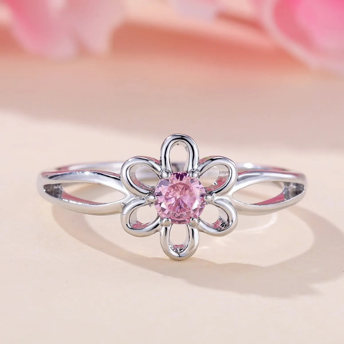 Women's flower-shaped hollow-out copper fashion ring in platinum pink diamond colour.