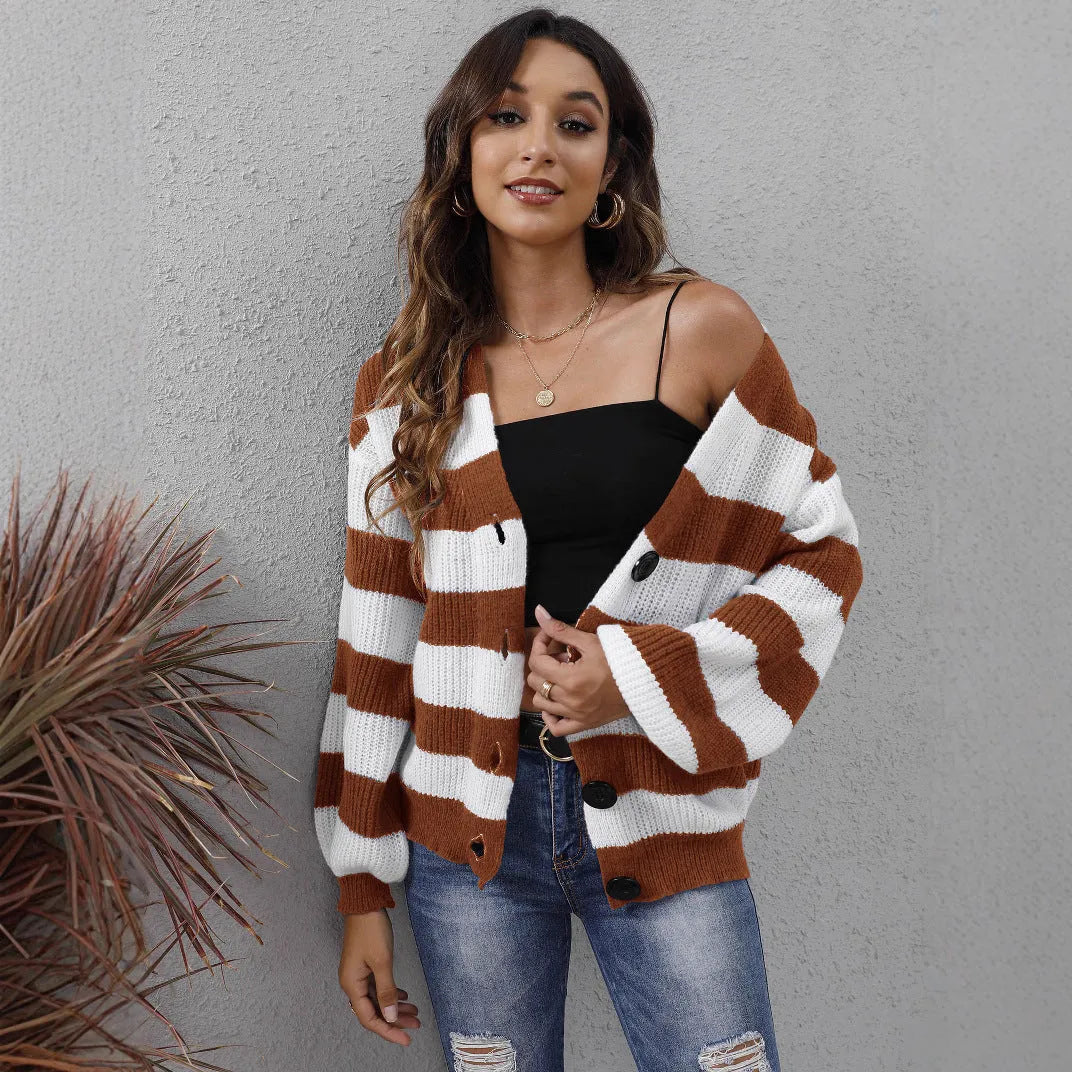 Blue striped women's cardigan sweater with button front and regular sleeves on a hanger.