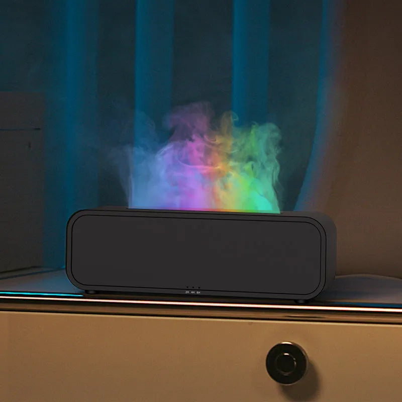 Black Flame Dynamic essential oil aroma diffuser with remote control on a wooden table, showing colour-changing LED lights.