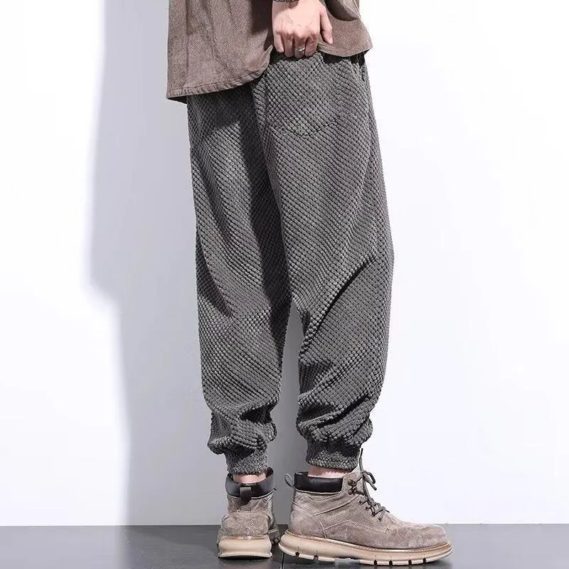 Men's grey straight-leg sweatpants with an adjustable ankle strap, laid flat.
