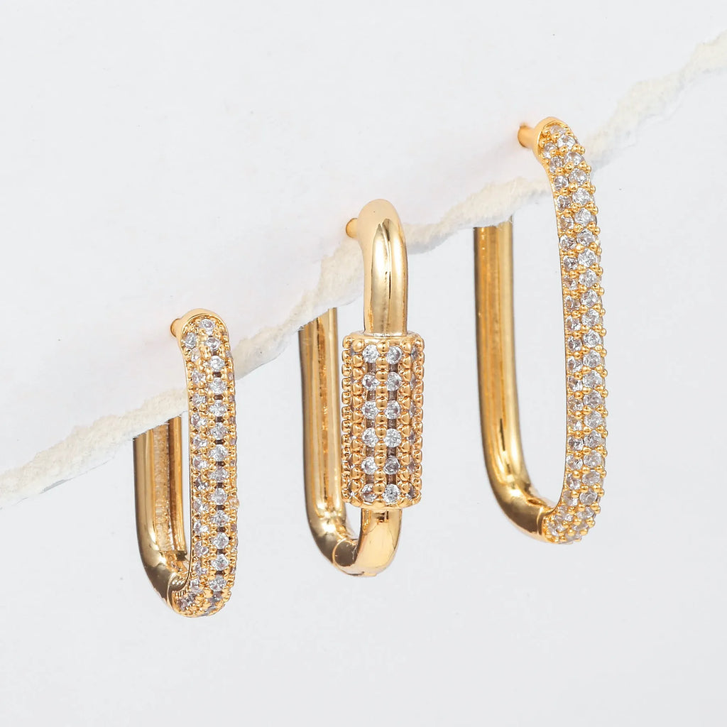 Three geometric square ear clips with inlaid zircon stones in gold and white gold colours