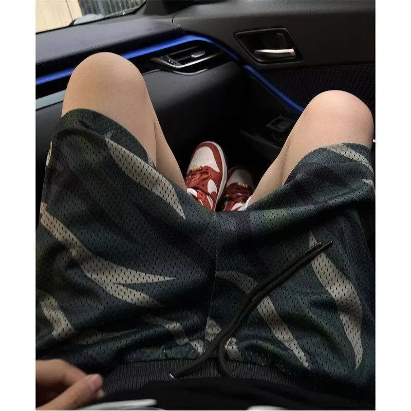 Men's straight-leg camouflage shorts in cotton blend fabric on a mannequin.