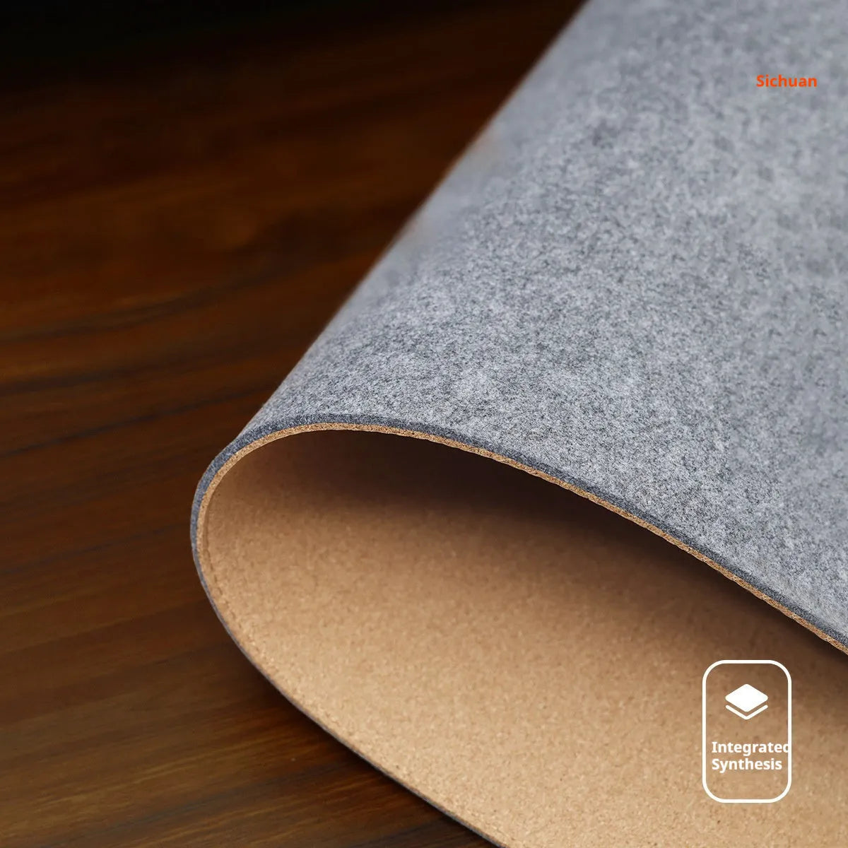Winter warm grey and black felt desk mouse mat with cork non-slip base on a wooden table.