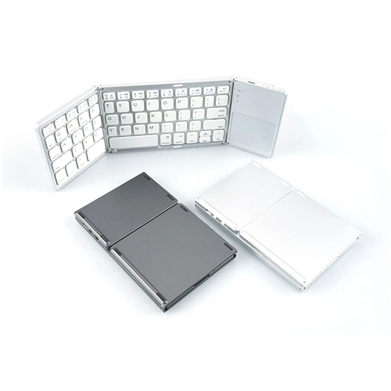 Black mini tri-fold Bluetooth keyboard unfolded next to a tablet, showing its compact size.