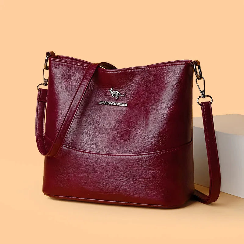 Women's soft leather shoulder bag in bucket design with minimalist luxury styling and mobile phone pocket