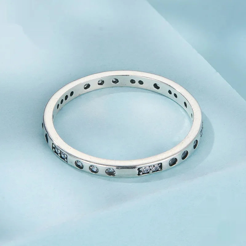 Simple silver Moss Password I Love You ring with oxidised black finish, shown on a model's finger.