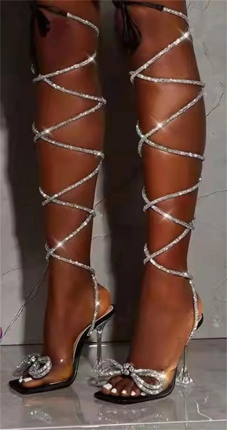 Plus size women's black strappy sandals with decorative Roman rhinestone straps and a square toe.