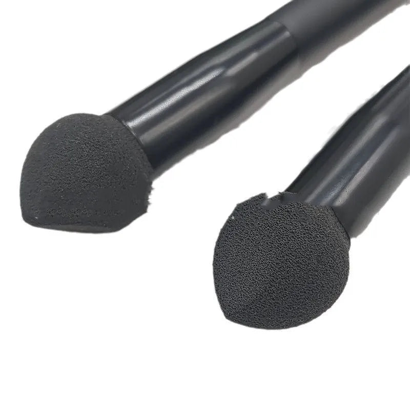 Black sponge-tip concealer brush with a wooden handle for covering dark circles.
