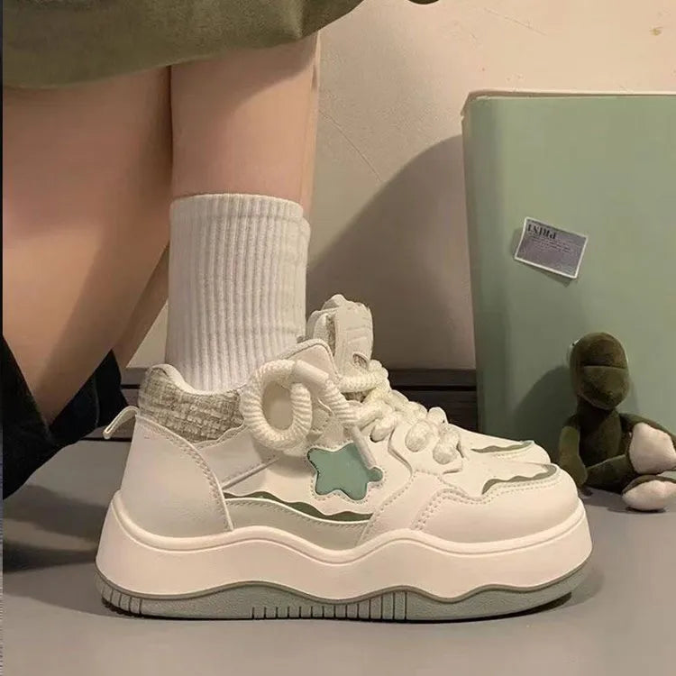 Women's green platform sneakers with patent leather finish and round toe front lace-up design
