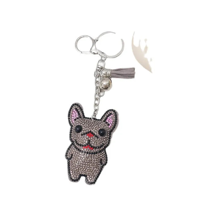 Close-up of a French dog-themed rhinestone keychain pendant with a cartoon bear design, in caramel colour.