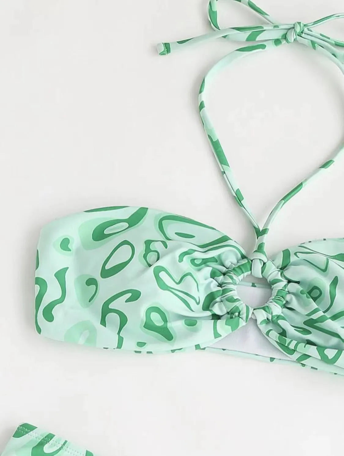 Women's blue floral bandeau bikini swimsuit with split style design on mannequin
