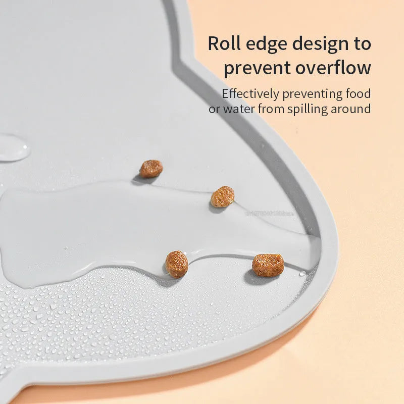 Blue silicone pet feeding mat with cat head design under food and water bowls