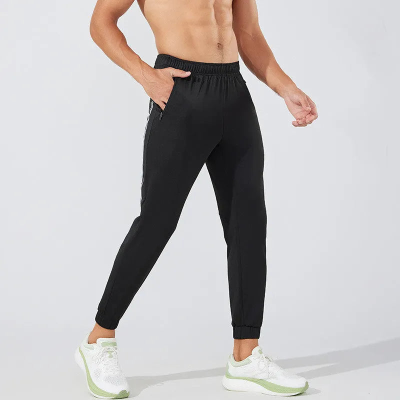 Men's black running trousers with mid waist design and standard length made from breathable polyester fabric