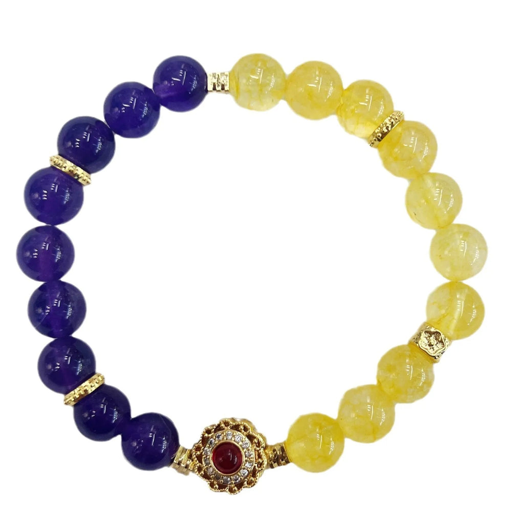 Handmade yellow and purple crystal women's bracelet on wrist.