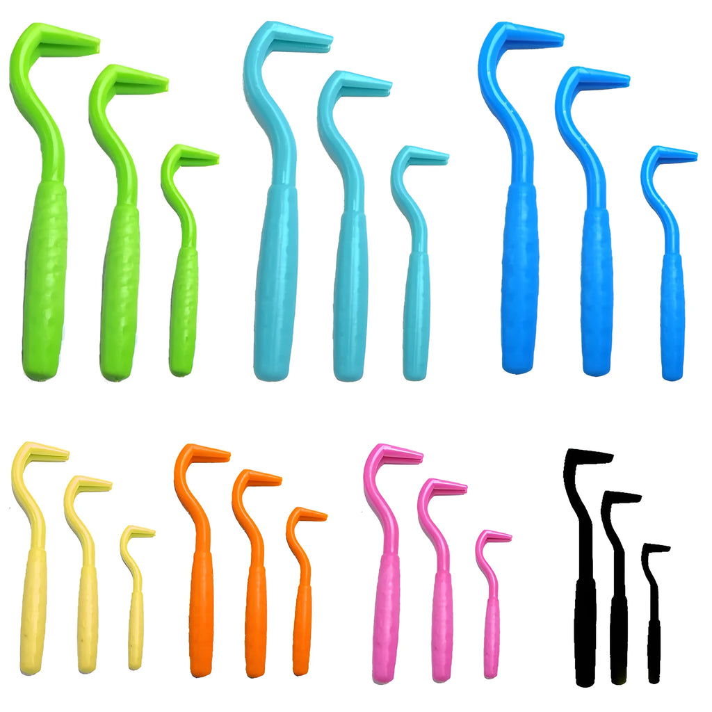 Set of three plastic tick removal hooks for dogs in various colours on a white background.
