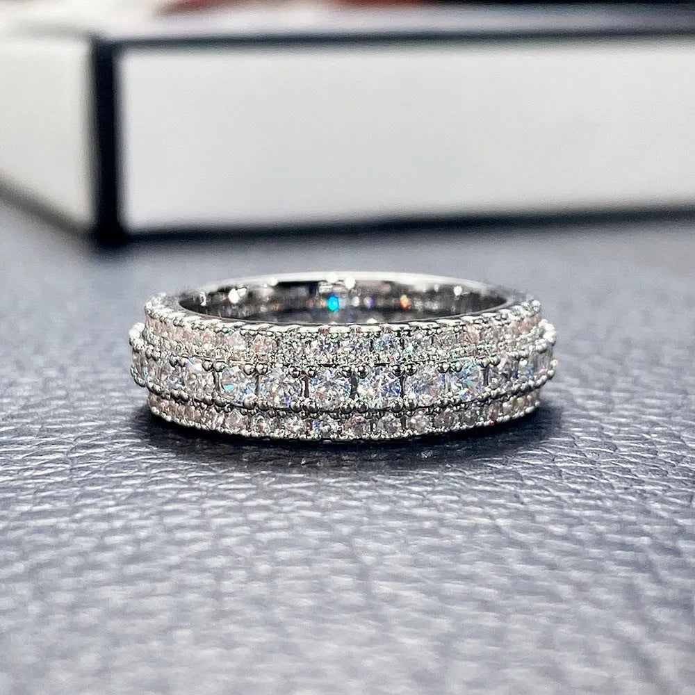Geometric triangular unisex ring with a central zircon stone, shown in white gold, yellow gold, and white and black plating options.