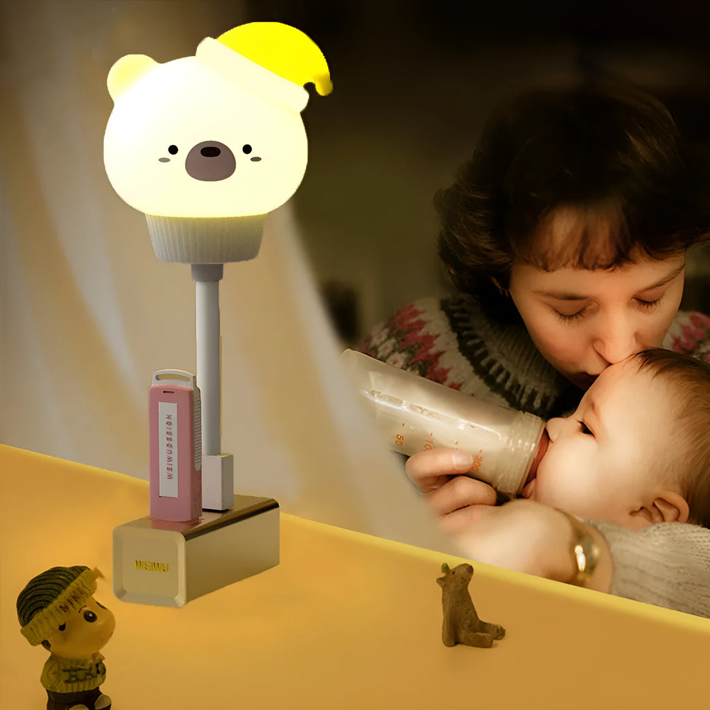 White cartoon bear-shaped USB night light with remote control on a wooden table.