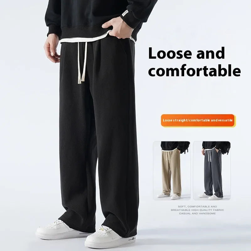 Men's apricot fleece-lined loose-fit sports casual trousers with elastic waist on a hanger.