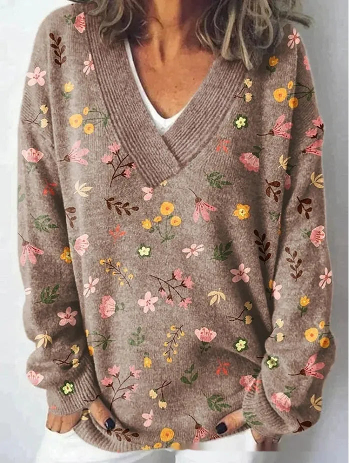 Women's V-neck sweatshirt with a white background and a textured 3D floral printed pattern.