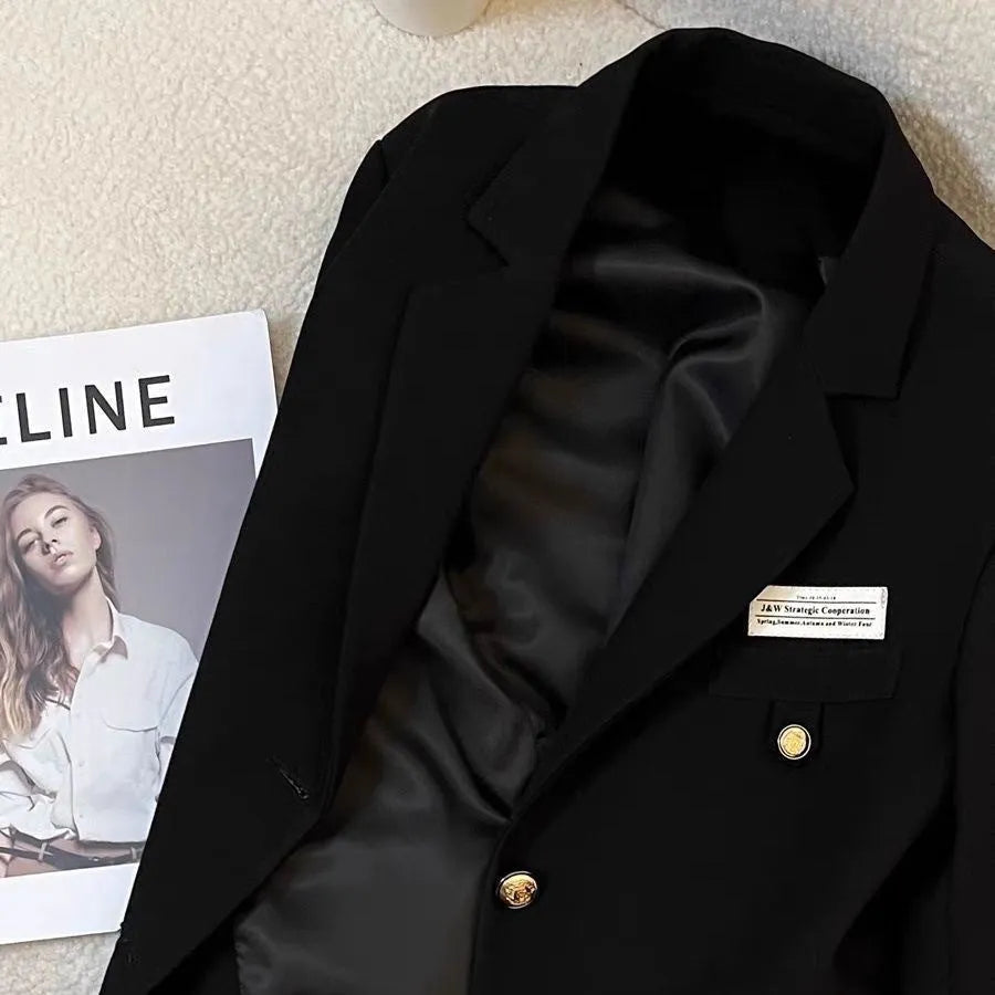 Women's black short suit coat with loose fit design and long sleeves
