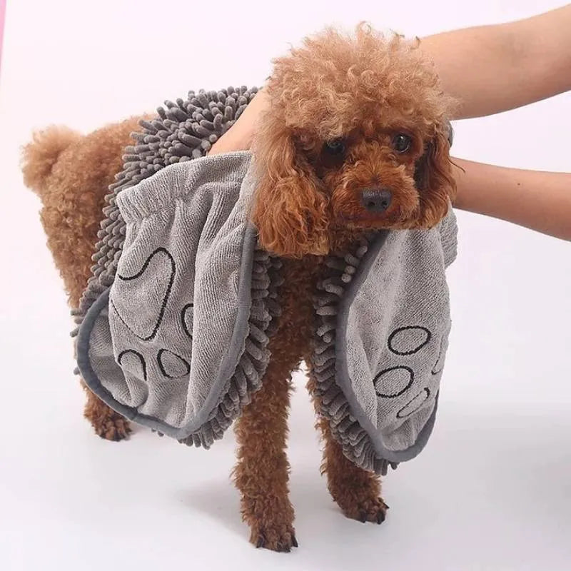 Blue pet bath robe towel wrapped around a small dog, showing its size and absorbent fabric.