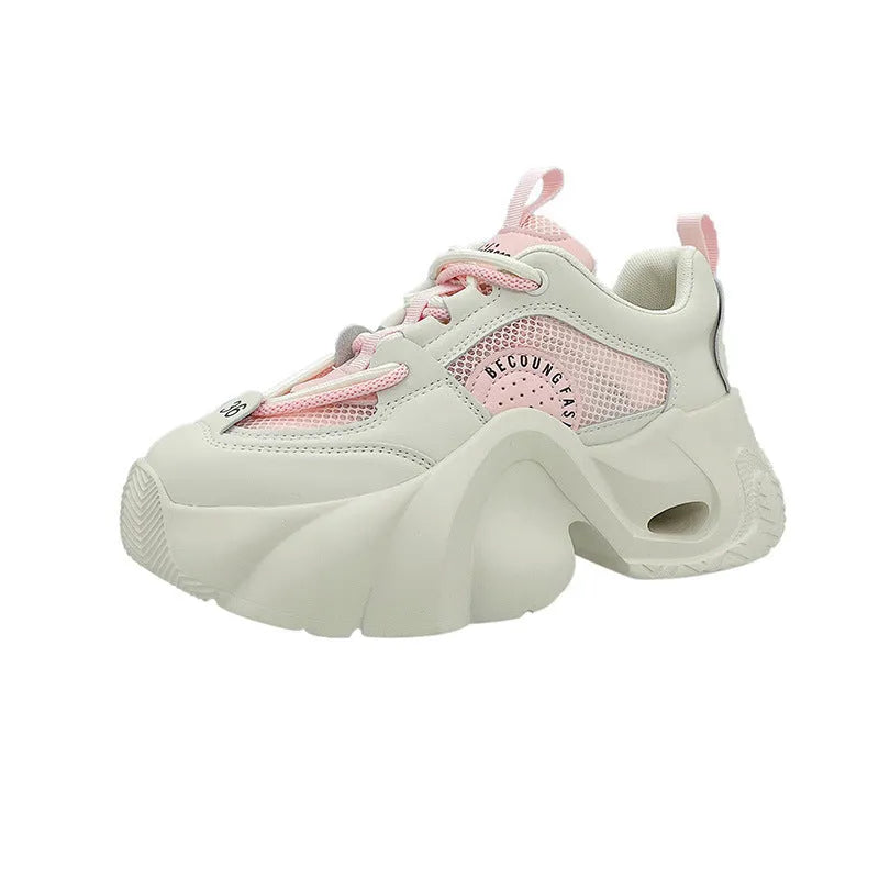 Women's pink sneakers with cross straps and thick sole showing side profile