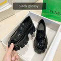 A pair of British style wide fit loafers with a shallow opening, shown in a choice of matte or glossy patent leather.