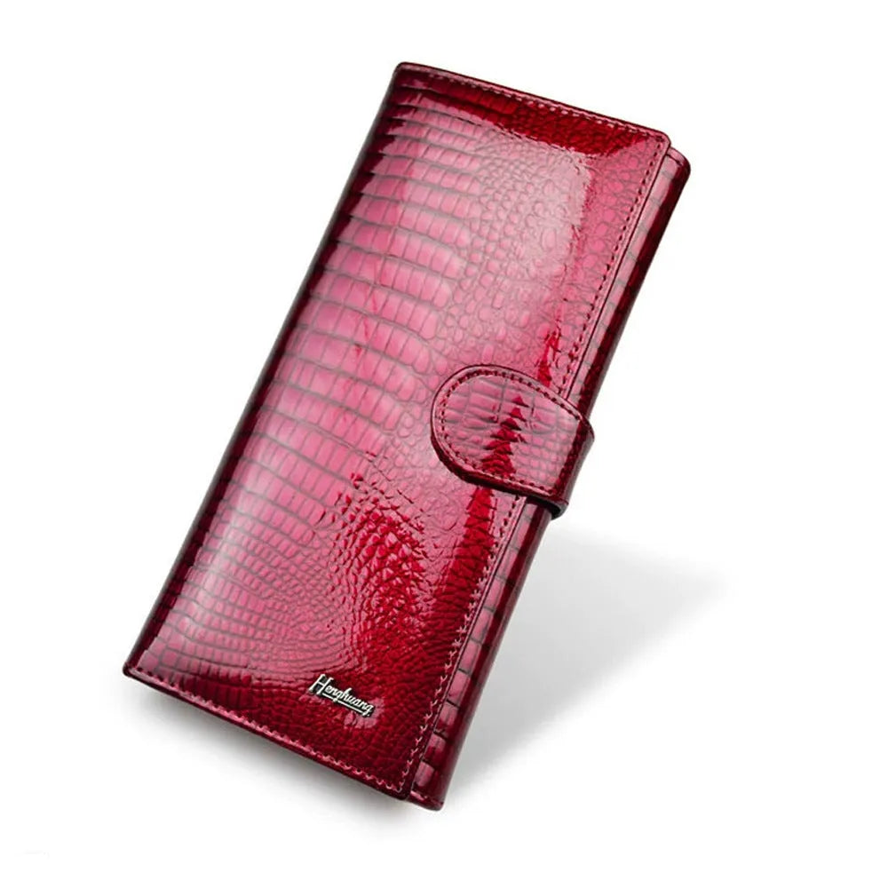 Women's patent leather coin purse with crocodile pattern in wine red colour showing pigskin lining