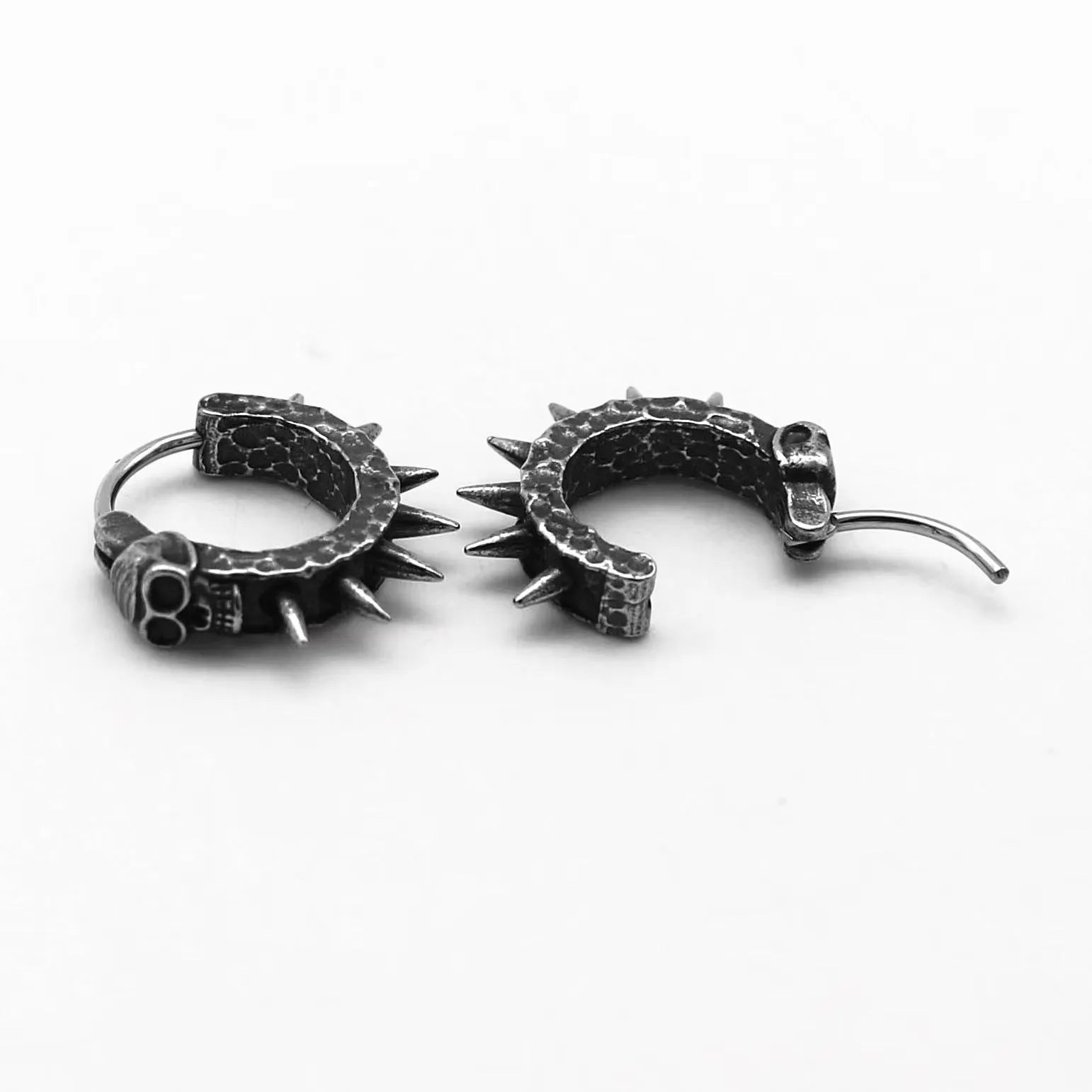 Close-up of black zinc alloy motorcycle-shaped earrings with copper-plated plastic punk details.