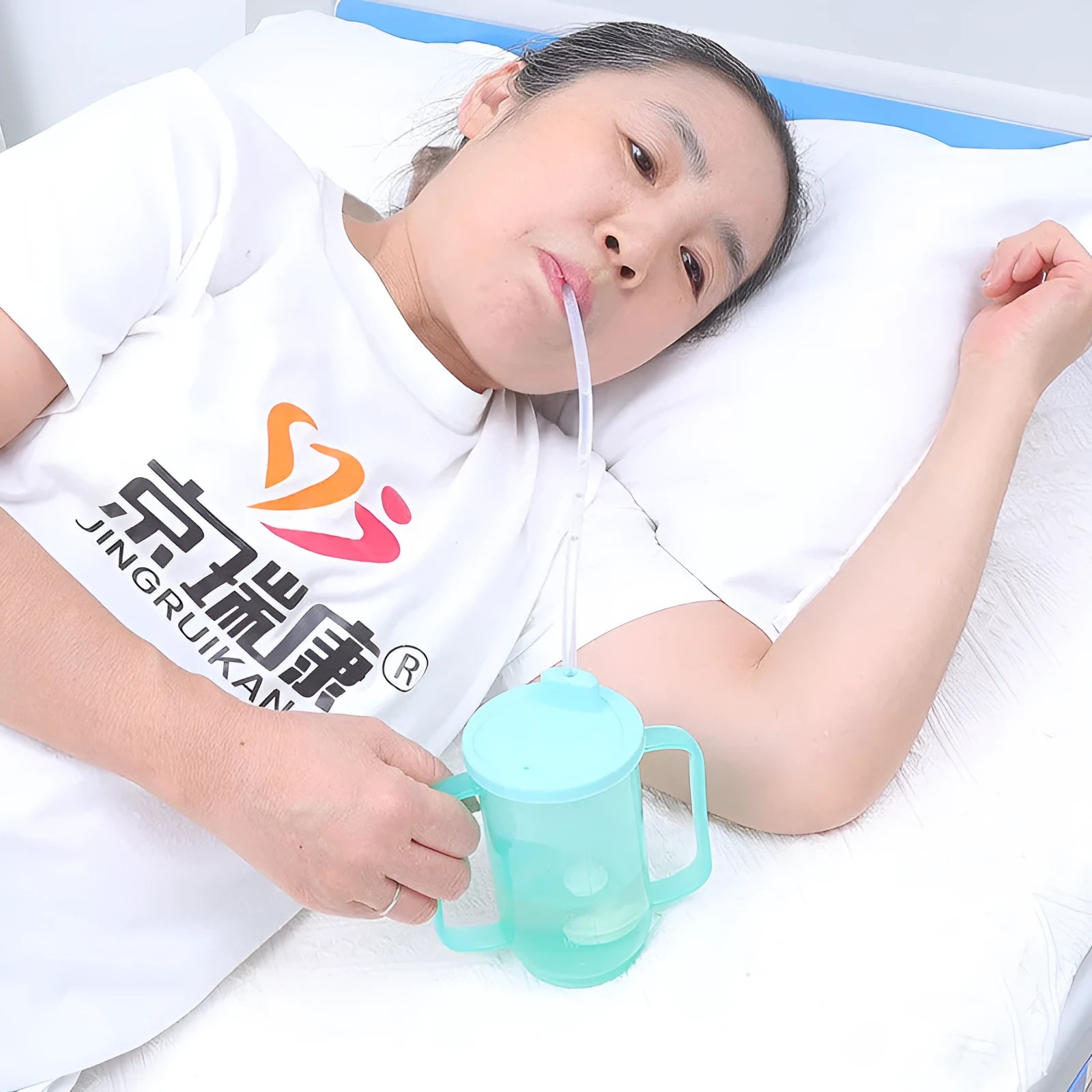 Bedside choke-proof drinking cup with slanted mouth and optional wrist strap for elderly and pregnant women