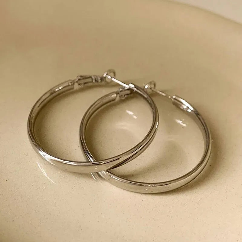 A pair of round gold-coloured metal hoop earrings on a 40mm diameter circle.